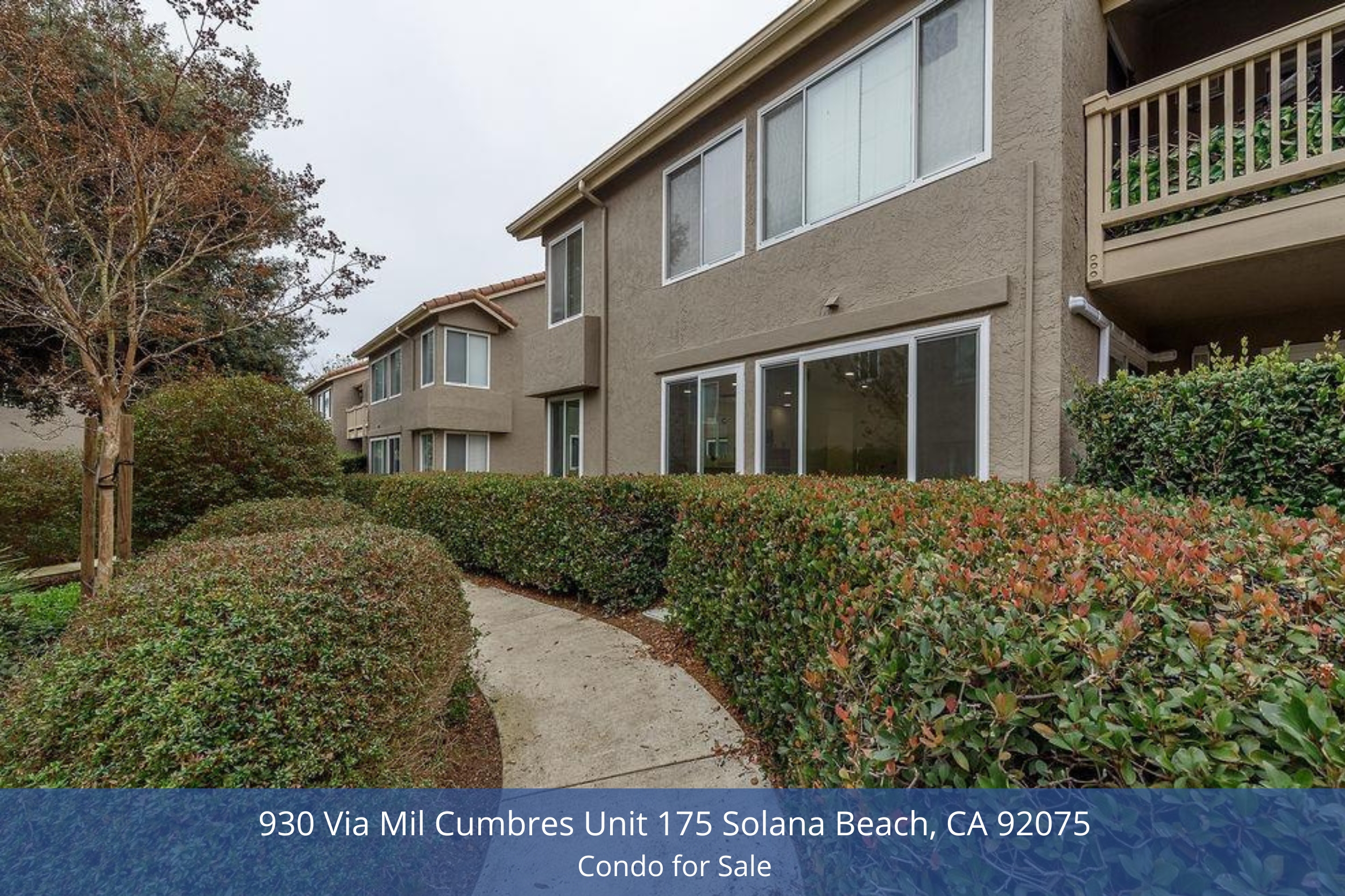 Exterior view of 930 Via Mil Cumbres Unit 175 Solana Beach, showcasing the well-maintained pathway lined with lush greenery leading to the entryway.