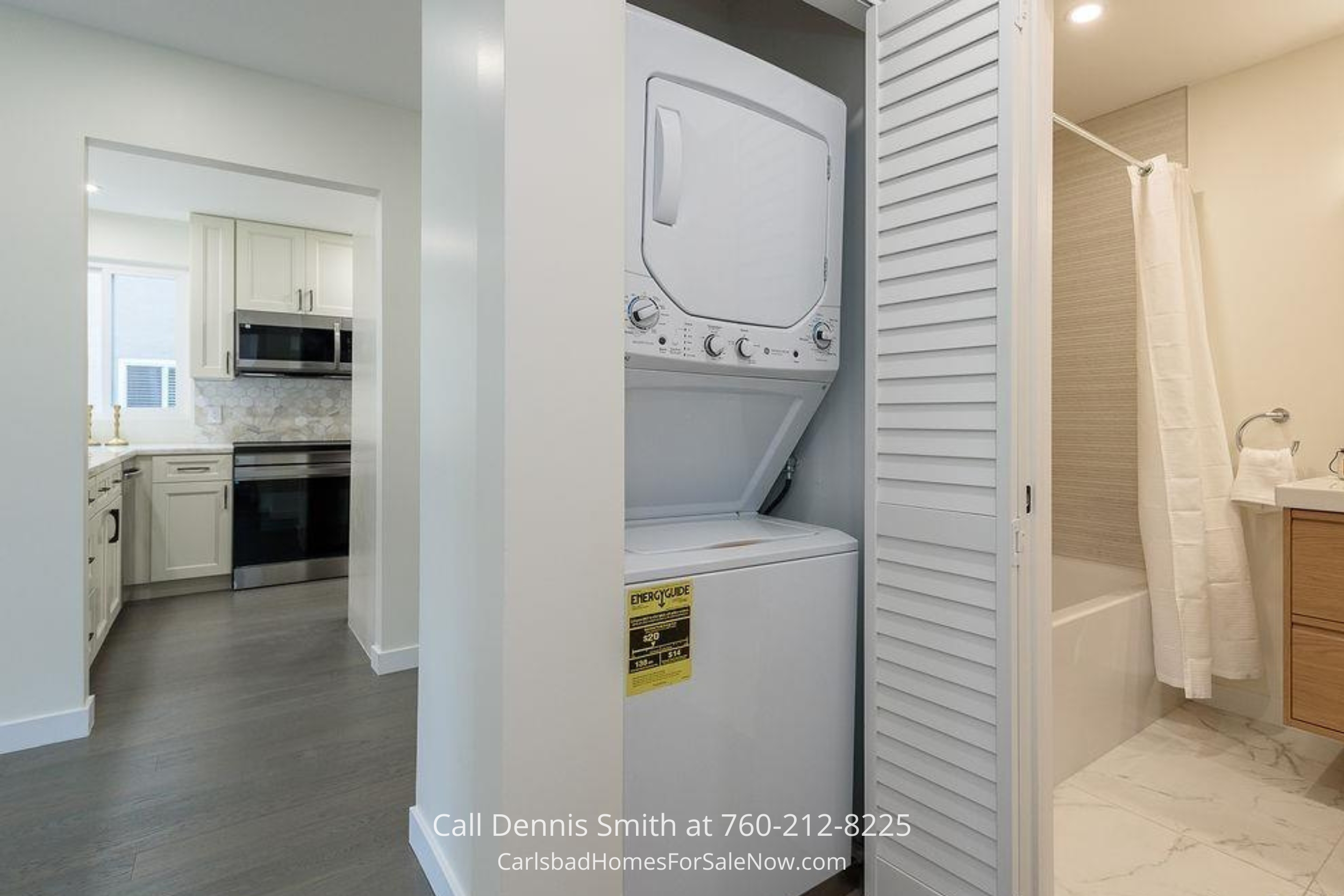 Convenient interior laundry setup with a stacked washer and dryer next to the kitchen in 930 Via Mil Cumbres Unit 175 Solana Beach condo.